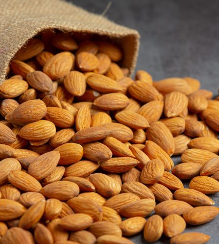 About almonds in bag from sackingl on dark background